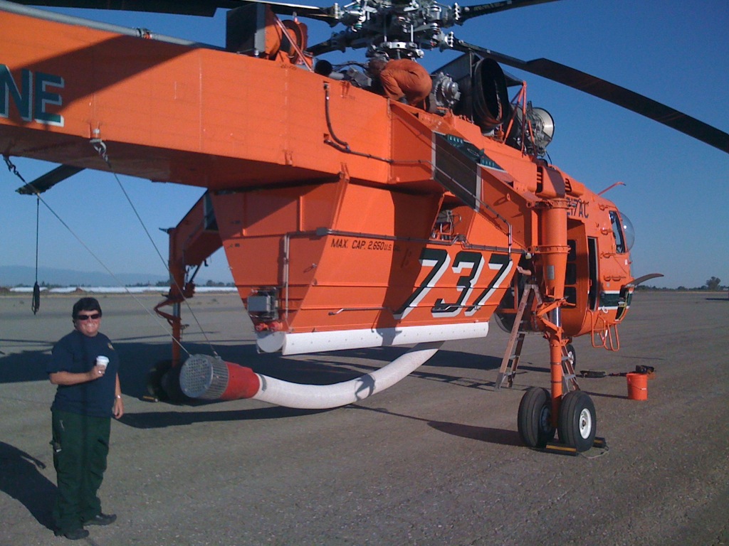 A special-pupose firefighting helicopter parked on an airstrip